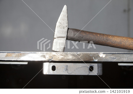 wooden handle hammer on steel plate wooden handle hammer on steel plate 142101919