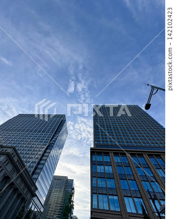 Clouds and sky reflected on the building Clouds and sky reflected on the building 142102423