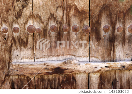 Close-up texture of an old weathered wooden door Close-up texture of an old weathered wooden door 142103023