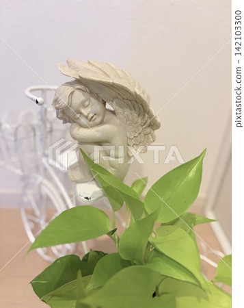 An angel sleeping surrounded by greenery An angel sleeping surrounded by greenery 142103300