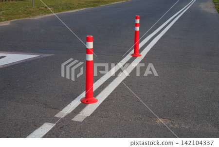 Red Flexible Traffic Delineator Posts Installed Near School Zone Road Markings Red Flexible Traffic Delineator Posts Installed Near School Zone Road Markings 142104337