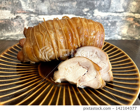Chicken thigh char siu, rolled with string, sliced cross-section. Chicken thigh char siu, rolled with string, sliced cross-section. 142104377
