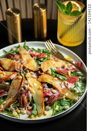 Salad with Pear, Arugula, Jamon, Blue Cheese and Blueberry, Delicious Fresh Salad Appetizer on Bright Background Salad with Pear, Arugula, Jamon, Blue Cheese and Blueberry, Delicious Fresh Salad Appetizer on Bright Background 142104510