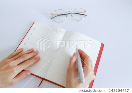 Hand writing on a notebook 142104757