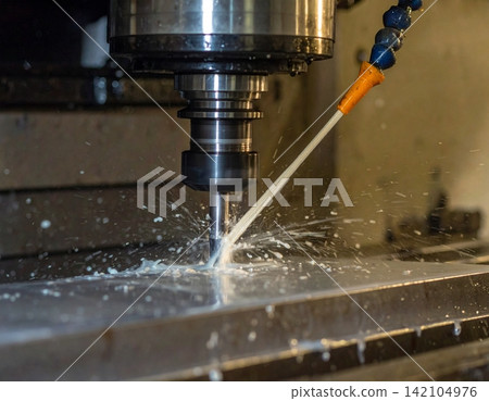 Close up CNC milling machine processing on steel with cooling Close up CNC milling machine processing on steel with cooling 142104976