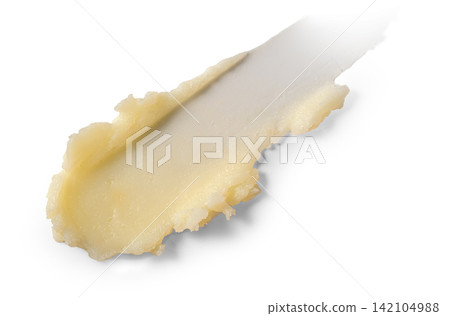 Creamy paste spreads smoothly across a clean white surface. Ideal for beauty, skincare, or food product visuals Creamy paste spreads smoothly across a clean white surface. Ideal for beauty, skincare, or food product visuals 142104988