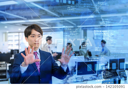 A man raises his hand to the air in an office. A man raises his hand to the air in an office. 142105091