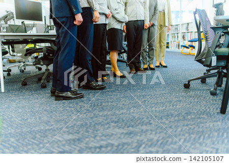 Business people standing in a line in the office Business people standing in a line in the office 142105107