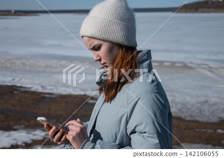Young woman calling for help on frozen lake Young woman calling for help on frozen lake 142106055
