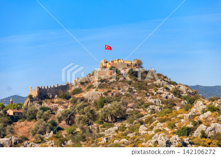 View of ancient Lycian town Simena with fortress on a mount on the coast of the Mediterranean sea in Antalya Province, Turkey View of ancient Lycian town Simena with fortress on a mount on the coast of the Mediterranean sea in Antalya Province, Turkey 142106272