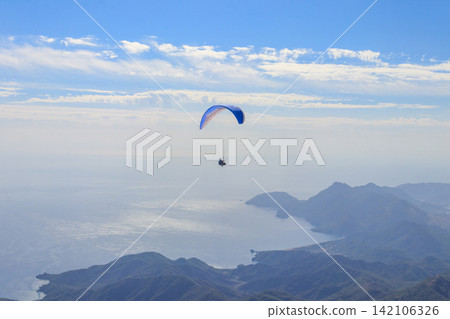 Paragliders flying from a top of Tahtali mountain near Kemer, Antalya Province in Turkey. Concept of active lifestyle and extreme sport adventure Paragliders flying from a top of Tahtali mountain near Kemer, Antalya Province in Turkey. Concept of active lifestyle and extreme sport adventure 142106326