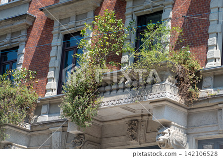 Traditional Green Balcony on the Brick Building in Como, Italy Traditional Green Balcony on the Brick Building in Como, Italy 142106528