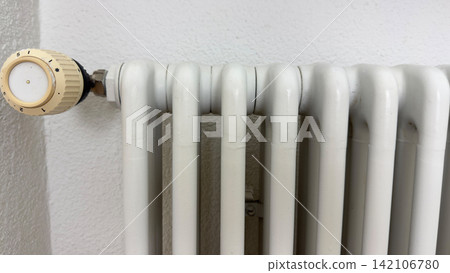 White home radiator close up metal heating fins interior detail of warm climate system clean minimal design energy efficient solution White home radiator close up metal heating fins interior detail of warm climate system clean minimal design energy efficient solution 142106780