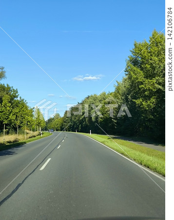 Traveling on a paved road in sunny weather Traveling on a paved road in sunny weather 142106784