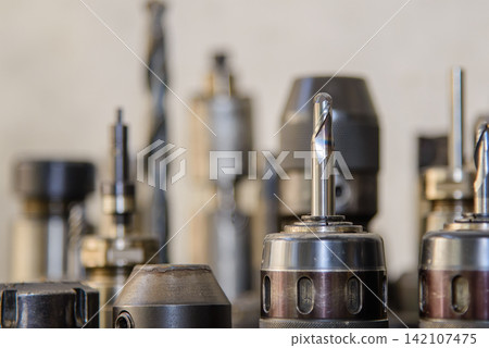 Close up of used ball nose end mill tool setup on CNC milling machine spindle Close up of used ball nose end mill tool setup on CNC milling machine spindle 142107475