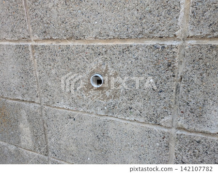 Piping pipes installed in a concrete block wall Piping pipes installed in a concrete block wall 142107782