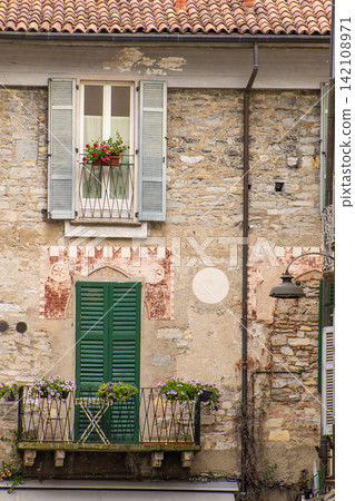 Beautiful Italian Balcony and Window Shutters in Como, Italy Beautiful Italian Balcony and Window Shutters in Como, Italy 142108971