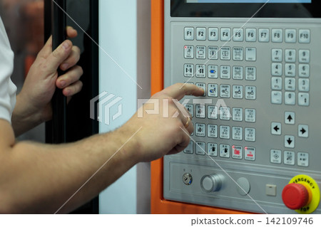 plastic injection molding machine operator at work plastic injection molding machine operator at work 142109746