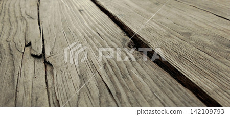 Rustic style wood planks that appear weathered, with deep grain and cracks. Rustic style wood planks that appear weathered, with deep grain and cracks. 142109793