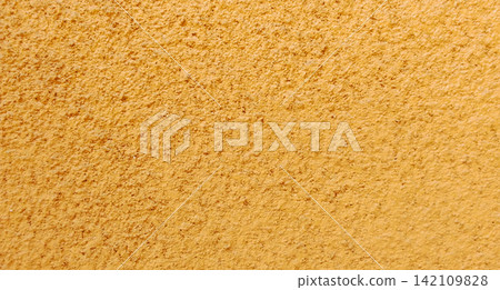 Background of a rough yellow stucco plaster wall texture Background of a rough yellow stucco plaster wall texture 142109828