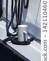 Mooring rope secured to a bollard on a ship deck, illustrating maritime work and dockside responsibilities in waterfront settings. 142110460