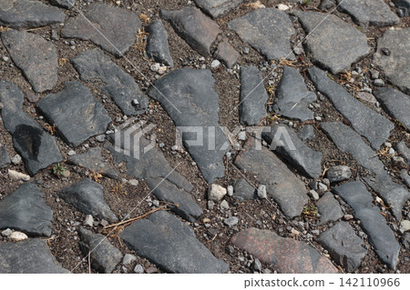 Old Cobblestone Pavement Surface with Large Stone Blocks and Small Gravel Old Cobblestone Pavement Surface with Large Stone Blocks and Small Gravel 142110966