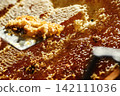 Beekeeper uncapping honeycomb frame with uncapping fork tool for honey extraction process 142111036