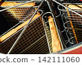 Beekeeper loading wooden frame with honeycomb into centrifugal honey extractor machine 142111060