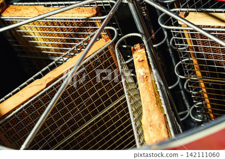 Beekeeper loading wooden frame with honeycomb into centrifugal honey extractor machine 142111060