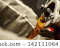Beekeeper loading wooden frame with honeycomb into centrifugal honey extractor machine 142111064