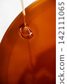 Beekeeper loading wooden frame with honeycomb into centrifugal honey extractor machine 142111065