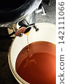 Beekeeper loading wooden frame with honeycomb into centrifugal honey extractor machine 142111066