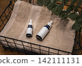 Two dropper bottles with blank labels and a green leafy 142111131