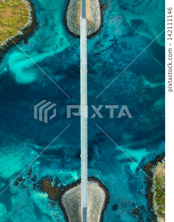 Aerial view of Fredvang bridges road over turquoise ocean water 142111146