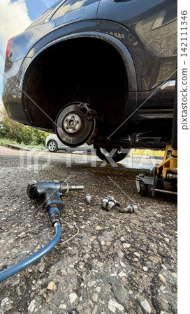 Brake disc and suspension of a lifted car during maintenance Brake disc and suspension of a lifted car during maintenance 142111346