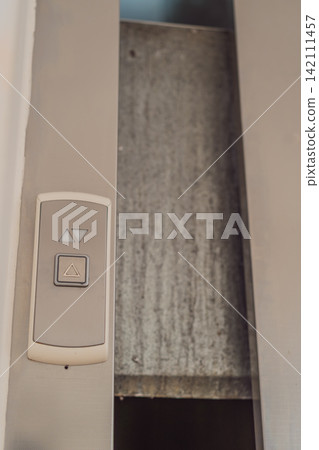 Elevator stuck between floors with doors open, showing lift malfunction, building safety issue, urban infrastructure problem and emergency risk concept Elevator stuck between floors with doors open, showing lift malfunction, building safety issue, urban infrastructure problem and emergency risk concept 142111457