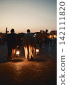 Silhouette of people at sunset in marrakech square Silhouette of people at sunset in marrakech square 142111820