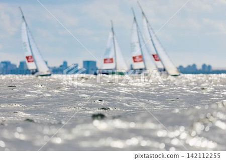 magic splashing water, Russia, St.Petersburg, Yachtsmen are sitting amicably on board of the sailing boat in sailing regatta in the Gulf of Finland at sunny day, teamwork magic splashing water, Russia, St.Petersburg, Yachtsmen are sitting amicably on board of the sailing boat in sailing regatta in the Gulf of Finland at sunny day, teamwork 142112255