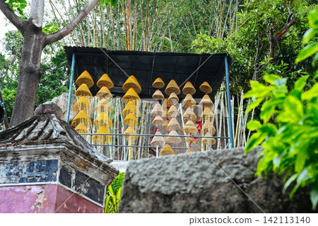 Traditional spiral incense coils hanging under a canopy roof at ancient A-Ma Temple built in 1488 surrounded by bamboo Traditional spiral incense coils hanging under a canopy roof at ancient A-Ma Temple built in 1488 surrounded by bamboo 142113140