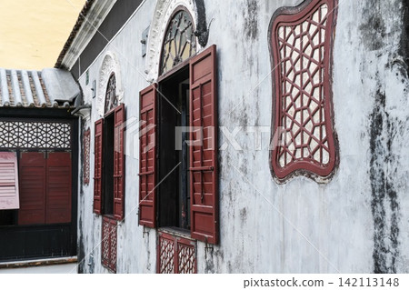 Traditional architecture details of Mandarin House built in 1869 with carved wooden lattices and arched window shutters 142113148