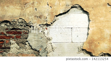 Weathered walls reveal concrete blocks and red bricks. Weathered walls reveal concrete blocks and red bricks. 142113254