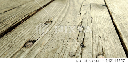Old weathered wooden plank with rusty nails and cracked texture. Old weathered wooden plank with rusty nails and cracked texture. 142113257