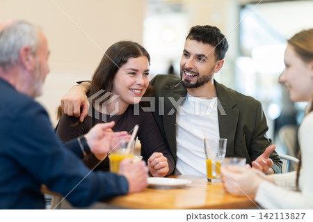 Family day. Multiage family drink coffee or juice in restaurant Family day. Multiage family drink coffee or juice in restaurant 142113827