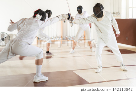 People at a group fencing lesson practice with rapier People at a group fencing lesson practice with rapier 142113842