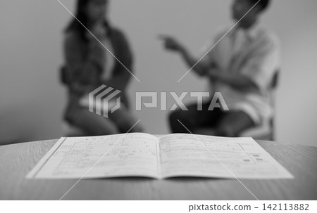 Divorce papers and images of men and women, in black and white. Divorce papers and images of men and women, in black and white. 142113882