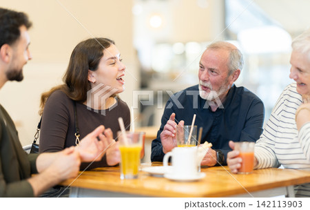 Family day. Multiage family drink coffee or juice in restaurant Family day. Multiage family drink coffee or juice in restaurant 142113903