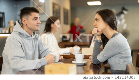 Girl in cafe sits near guy companion, has nice conversation Girl in cafe sits near guy companion, has nice conversation 142114305