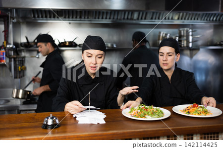 Dissatisfied female chef finds out why the dishes do not match paid check Dissatisfied female chef finds out why the dishes do not match paid check 142114425