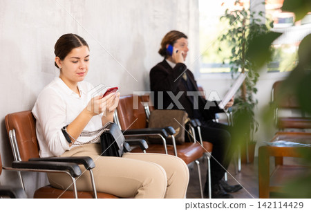 Young woman in business clothes reading message on phone 142114429