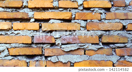 Rustic red brick wall texture with rough cement mortar. Rustic red brick wall texture with rough cement mortar. 142114582